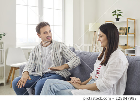 Happy Couple Laughing And Conversing At Home Together 129847982