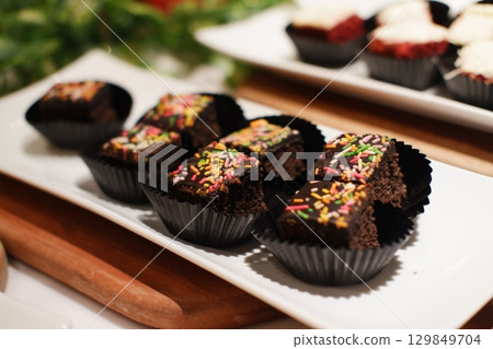 Delicious Chocolate Cake Bites Decorated with Sprinkles 129849704