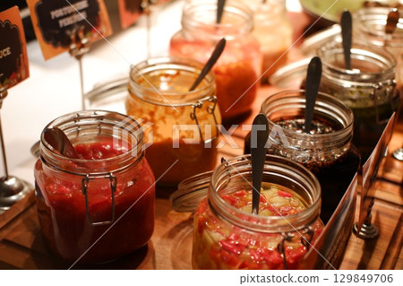Colorful Assortment of Condiments on Buffet Table Colorful Assortment of Condiments on Buffet Table 129849706