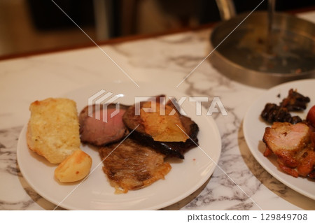 Assorted Grilled Meat and Bread on White Plate 129849708