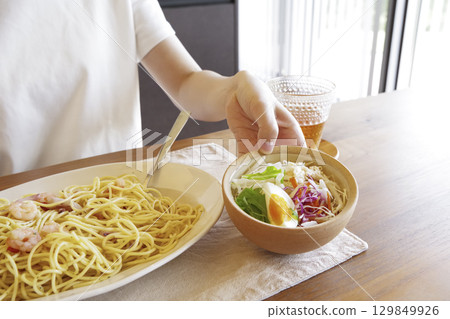 Woman eating delicious pasta Woman eating delicious pasta 129849926