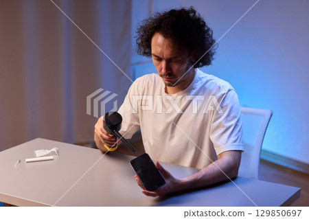 The Innovative Smartphone Cleaning Device is Being Demonstrated During Use and Functionality 129850697