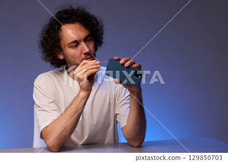 The Innovative Smartphone Cleaning Device is Being Demonstrated During Use and Functionality The Innovative Smartphone Cleaning Device is Being Demonstrated During Use and Functionality 129850703