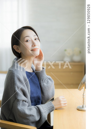 A woman wearing knitwear who is concerned about rough skin A woman wearing knitwear who is concerned about rough skin 129850926