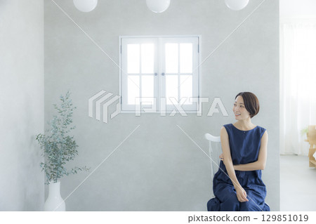 Woman sitting on chair Woman sitting on chair 129851019