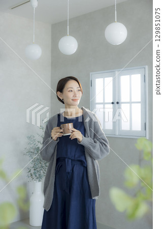 A woman drinking coffee A woman drinking coffee 129851075