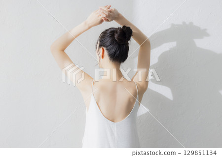 A young woman's back view A young woman's back view 129851134