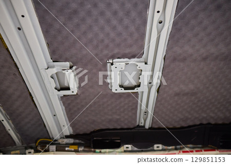 This is an Interior View of a Vehicle Ceiling which features Upholstered Panels and Structure This is an Interior View of a Vehicle Ceiling which features Upholstered Panels and Structure 129851153