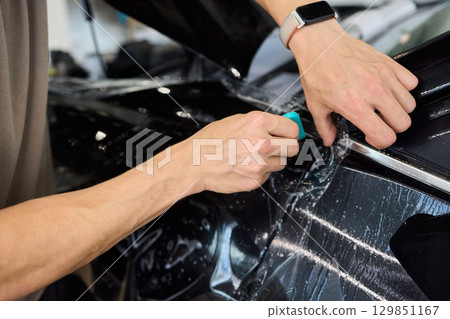 Applying a Protective Film on the Surface of Your Car for Enhanced Durability and Shine Applying a Protective Film on the Surface of Your Car for Enhanced Durability and Shine 129851167
