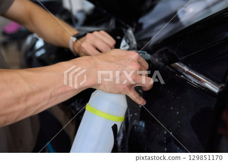 Applying a Protective Film on the Surface of Your Car for Enhanced Durability and Shine 129851170