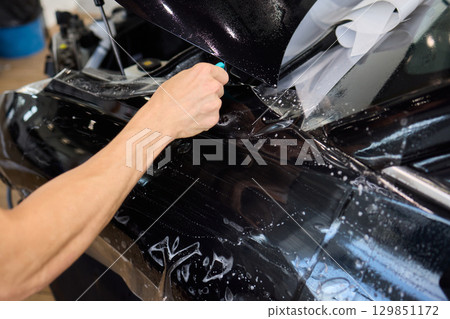 Applying a Protective Film on the Surface of Your Car for Enhanced Durability and Shine Applying a Protective Film on the Surface of Your Car for Enhanced Durability and Shine 129851172