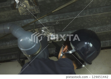 Young female worker working at a construction site 129851442