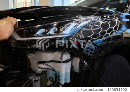 Applying a Protective Film on the Surface of Your Car for Enhanced Durability and Shine 129851590