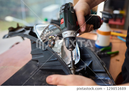 Careful precision is essential when installing a car headlight assembly for optimal performance Careful precision is essential when installing a car headlight assembly for optimal performance 129851689