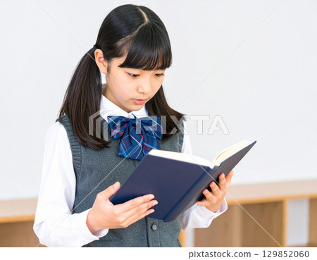 Girls reading a book 129852060
