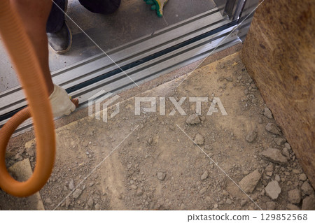 The area designated for construction is filled with dust and contains essential cleaning equipment The area designated for construction is filled with dust and contains essential cleaning equipment 129852568