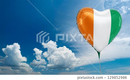 Ivory Coast flag heart shaped balloon and blue sky 129852986
