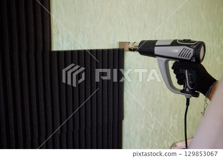 Applying Soundproof Foam Panels Securely Using a Hot Glue Gun for Better Performance and Insulation 129853067