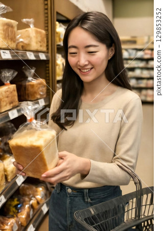 Generate a scene of picking up a loaf of bread at the bakery 129853252