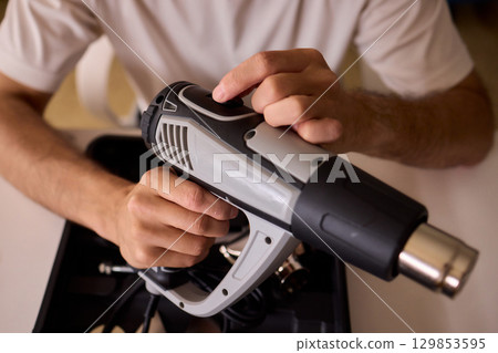 This versatile heat gun is ideal for various DIY projects, home repairs, and renovations This versatile heat gun is ideal for various DIY projects, home repairs, and renovations 129853595