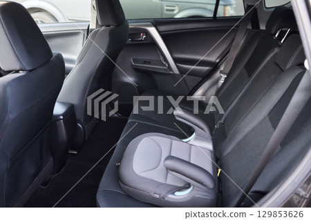 A detailed and aesthetically pleasing interior view showcasing a modern cars rear seat area 129853626