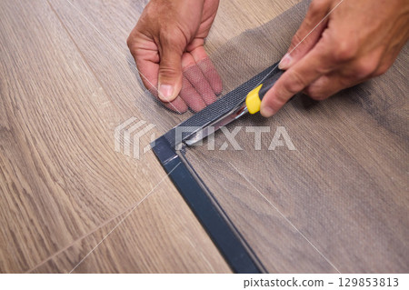 The process of cutting vinyl flooring accurately is essential for achieving a perfect fit The process of cutting vinyl flooring accurately is essential for achieving a perfect fit 129853813