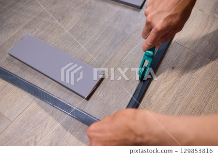 The process of cutting vinyl flooring accurately is essential for achieving a perfect fit The process of cutting vinyl flooring accurately is essential for achieving a perfect fit 129853816