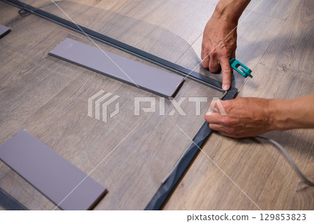 The process of cutting vinyl flooring accurately is essential for achieving a perfect fit The process of cutting vinyl flooring accurately is essential for achieving a perfect fit 129853823