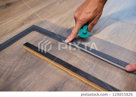 The process of cutting vinyl flooring accurately is essential for achieving a perfect fit The process of cutting vinyl flooring accurately is essential for achieving a perfect fit 129853826
