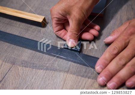 The process of cutting vinyl flooring accurately is essential for achieving a perfect fit The process of cutting vinyl flooring accurately is essential for achieving a perfect fit 129853827