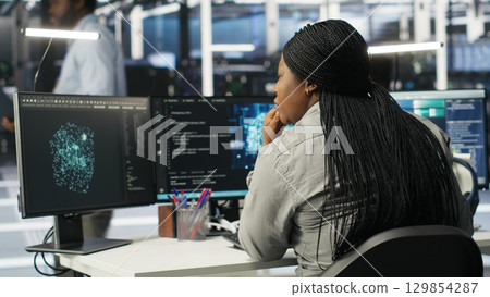 Server farm IT specialist using PC to apply artificial intelligence technology minimizing system downtime. Engineer using computer to develop and deploy AI solutions optimizing equipment, camera B Server farm IT specialist using PC to apply artificial intelligence technology minimizing system downtime. Engineer using computer to develop and deploy AI solutions optimizing equipment, camera B 129854287