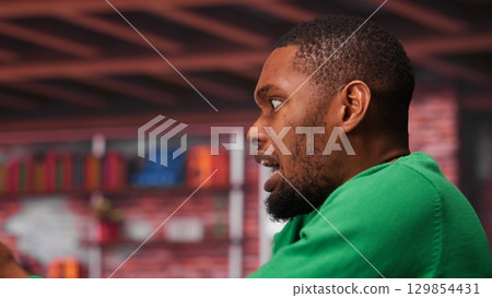 Upset broker distraught after losing money in cryptocurrency, falling for investment scam due to rug pull. Unhappy worried guy in bankruptcy crisis, financial loss after risky trade. Camera A. 129854431