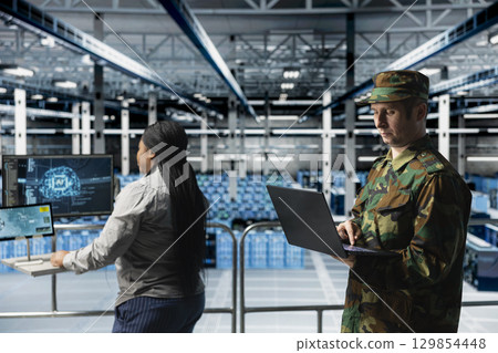 Team of army tech experts in data center conducting threat simulations using AI neural networks. Teamworking server farm colleagues using artificial intelligence supporting military operations 129854448