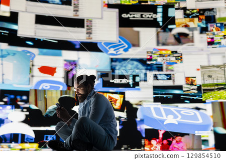 Young guy in misery is affected by anxiety and social depression, highlights suffering due to dangerous social media overuse. Expressive information from constant interaction causes distress. 129854510