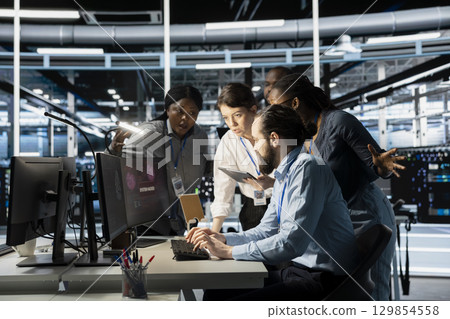 Engineers reviewing AI systems alerts after detecting irregular network activity patterns. IT team evaluating flagged events using artificial intelligence threat detection tools 129854558