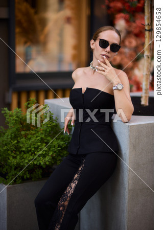 An Elegant Outdoor Fashion Photo Shoot Featuring Trendy Modern Accessories and Attire An Elegant Outdoor Fashion Photo Shoot Featuring Trendy Modern Accessories and Attire 129854658
