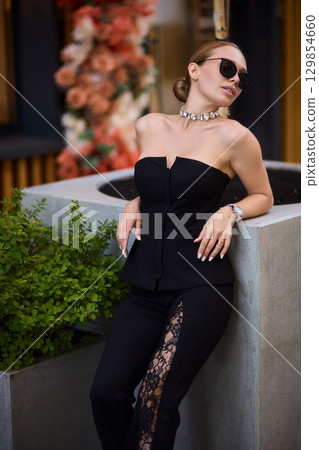 An Elegant Outdoor Fashion Photo Shoot Featuring Trendy Modern Accessories and Attire An Elegant Outdoor Fashion Photo Shoot Featuring Trendy Modern Accessories and Attire 129854660