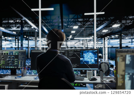 Server room IT worker deploying AI tools to automate repetitive workflows. Data center programmer managing large datasets used in AI training procedures to streamline tasks 129854720