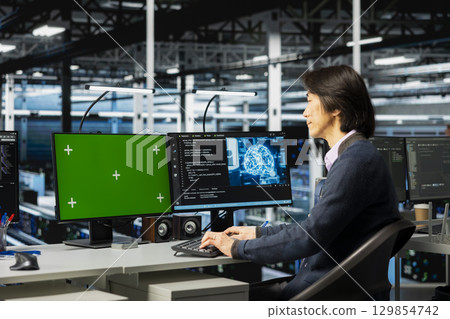 Server farm IT professional using green screen PC, deploying deep learning tools to automate repetitive workflows. Data center admin using chroma key computer, managing datasets used in AI training 129854742