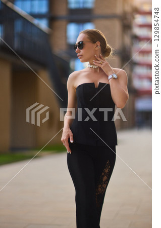 An Elegant Fashion Portrait Featuring a Beautiful Woman in a Stylish and Trendy Outfit 129854748