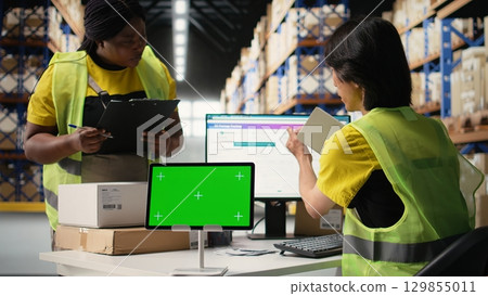 Asian employee uses a isolated mockup screen on computer, business software used for supply chain system and package tracking service. Real-time order fulfillment displays. Camera A. Asian employee uses a isolated mockup screen on computer, business software used for supply chain system and package tracking service. Real-time order fulfillment displays. Camera A. 129855011