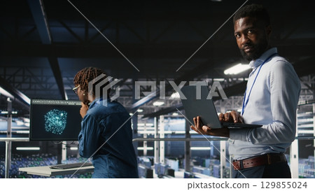 Smiling data center engineering team on industrial platform collaborating on neural network software tasks. Jolly server hub colleagues working together, visualizing large language model architecture Smiling data center engineering team on industrial platform collaborating on neural network software tasks. Jolly server hub colleagues working together, visualizing large language model architecture 129855024