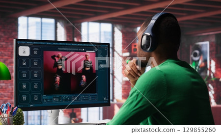 African American IT expert using AI technology to generate realistic images from text prompts. Young adult engaging with artificial intelligence tools online, text to image. Camera A. 129855260