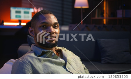 Analyst examining monthly budget and expenses to provide strategic advice on products and services. Black young business expert analyzing revenue balance, accounting at home. Camera A. 129855303