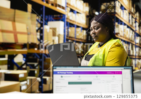 African american depot employee manages a shipping depot with packages ready for delivery. Staff handling inventory and performing quality control, local distribution across the region. 129855375
