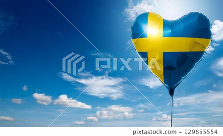 Swedish flag heart shaped balloon and blue sky 129855554