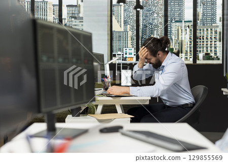 Trader doing face palm, upset by stock market crash triggered by Black Swan event causing drops in share prices. Financial specialist stressed by recession news decreasing markets valuation Trader doing face palm, upset by stock market crash triggered by Black Swan event causing drops in share prices. Financial specialist stressed by recession news decreasing markets valuation 129855569