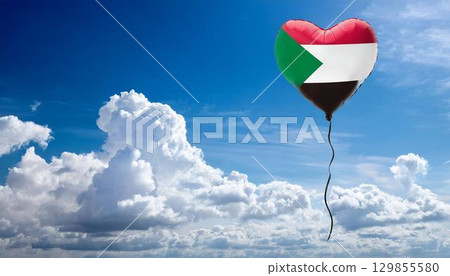 Sudanese flag heart shaped balloon and blue sky 129855580