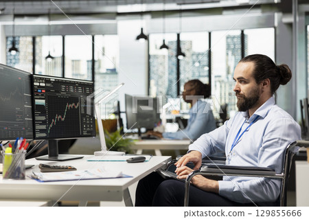 Day trader with disability in inclusive office buying and selling stocks. Prop firm employee with paraplegia in wheelchair analyzing stock exchange price movements for fast profit opportunities Day trader with disability in inclusive office buying and selling stocks. Prop firm employee with paraplegia in wheelchair analyzing stock exchange price movements for fast profit opportunities 129855666