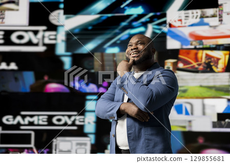 African american young guy connected to a global network through mobile devices, opening apps and streaming services platforms. Emphasizing communication and user interface evolution. 129855681